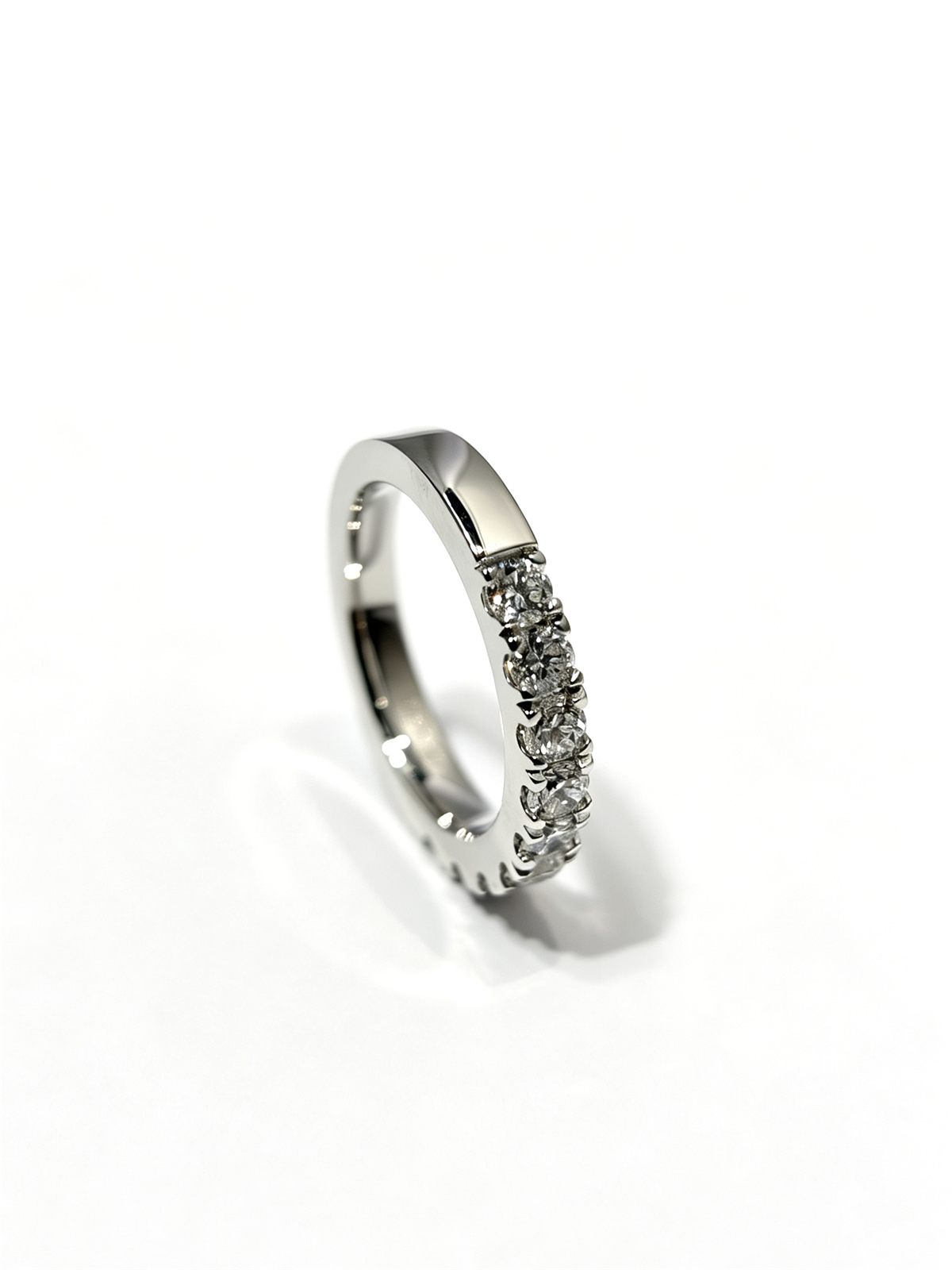Sterling silver ring with a lab grown diamond setting, shown before and after tarnish removal